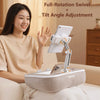 A woman is using a full-rotation swivel and tilt angle adjustment phone stand on a lap desk.