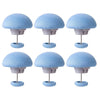 A set of six light blue non-slip duvet cover clips with dome-shaped heads and metal stands.