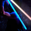 A person holds a glowing blue lightsaber, demonstrating dynamic light and sound effects.