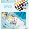 A watercolor paint set featuring various colors and water brush pens, displayed in an open box and on a white surface.