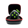 A black 12-sided fidget cube with green dots is shown inside a black storage case.