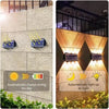 Solar powered LED wall lights illuminating a building facade during the day and night