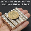 A hand holds several small silver disc magnets with various sizes and shapes.
