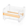 Clear plastic storage box for a creative washi tape cutter with an orange tape roll inside