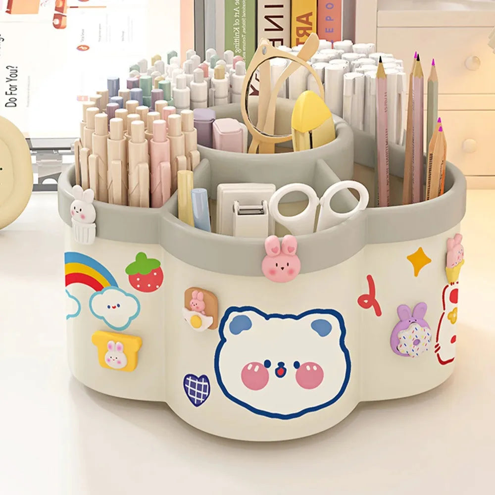 A light gray rotating desk organizer holding various pens, pencils, and supplies in a round container.