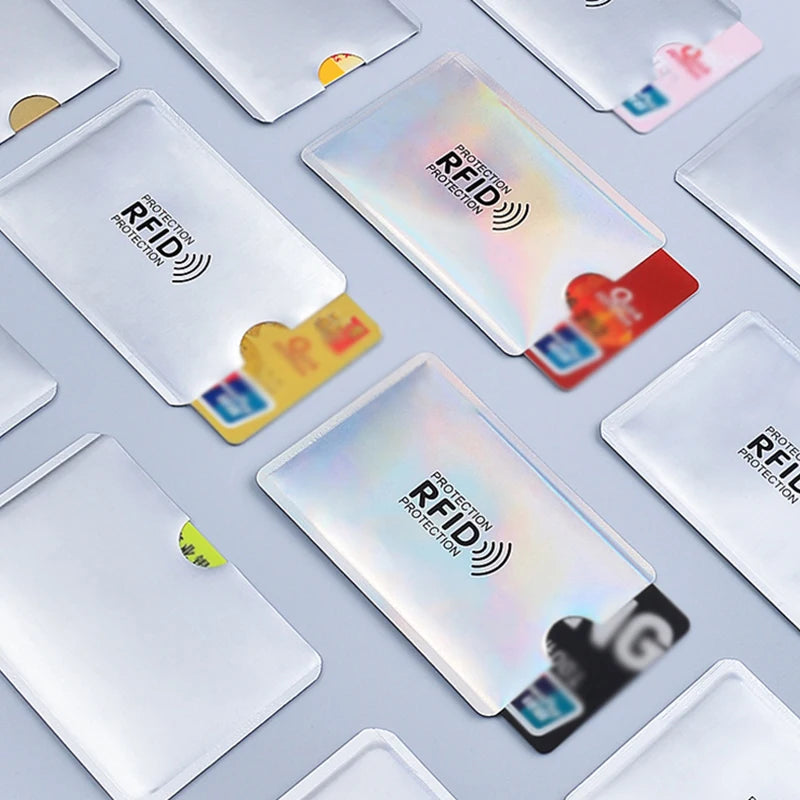A collection of plastic card sleeves designed for RFID and NFC protection, shown in various colors and angles.