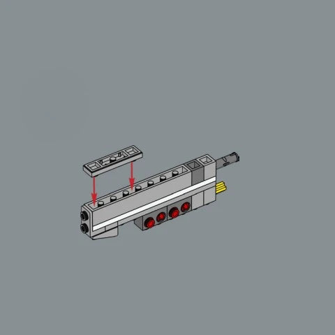 Modelo de bloque de construcción de la Millennium Falcon plateada con una pieza superior insertada en el cuerpo principal.
