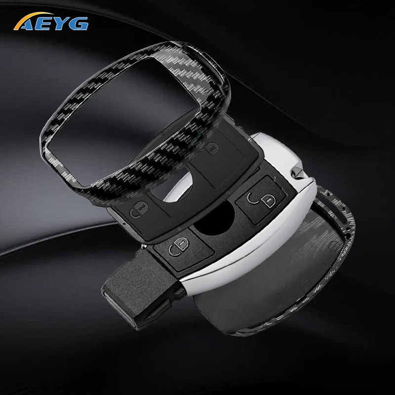 A black slim carbon fiber car key cover with a silver finish shown in a close-up view.