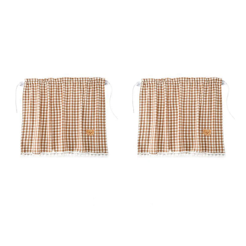 A pair of brown and tan checkered sun shade curtains with lace trim.