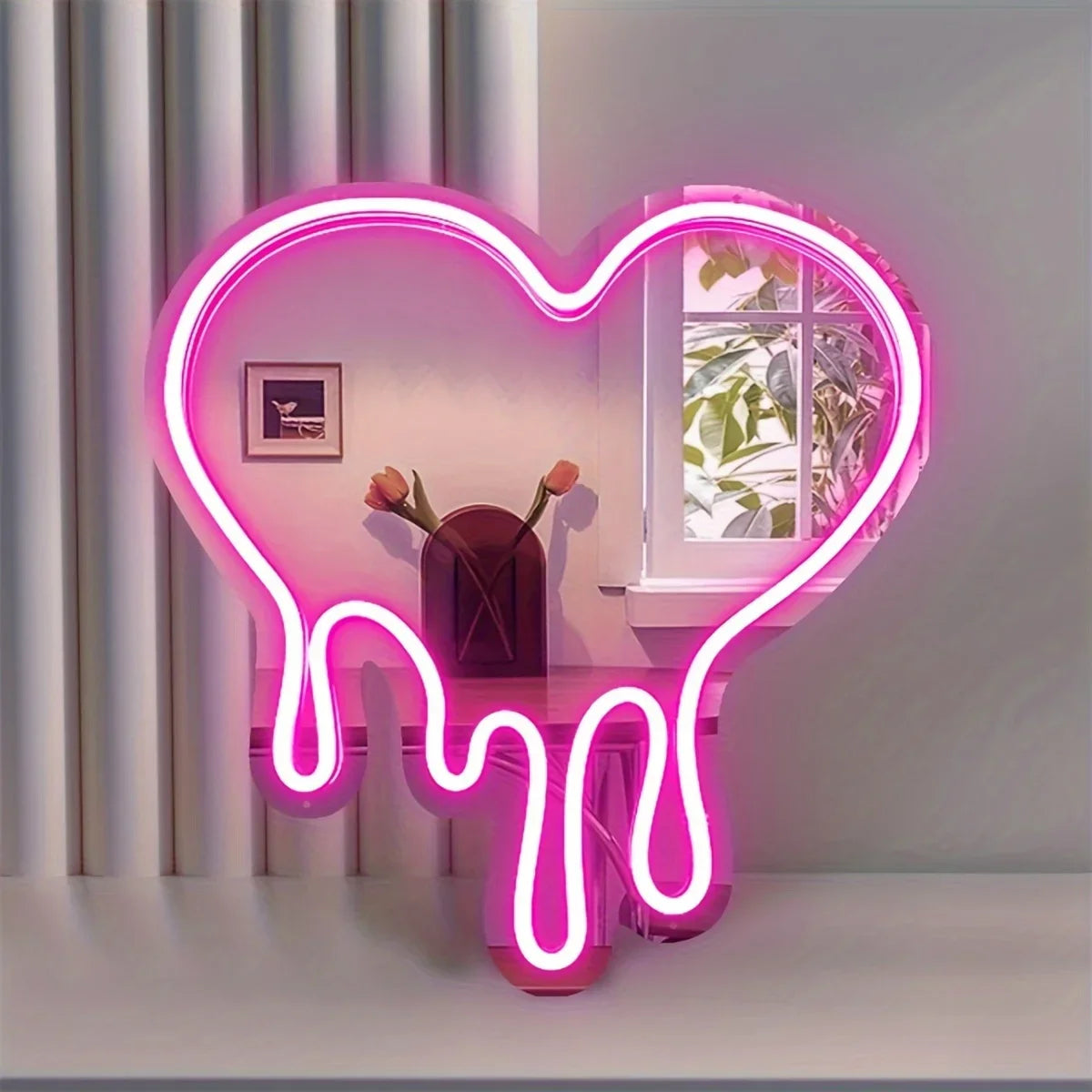 A neon sign shaped like a heart dripping with pink light, displayed on a shelf.