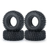 A set of black rubber mud terrain tires stacked on a white background.