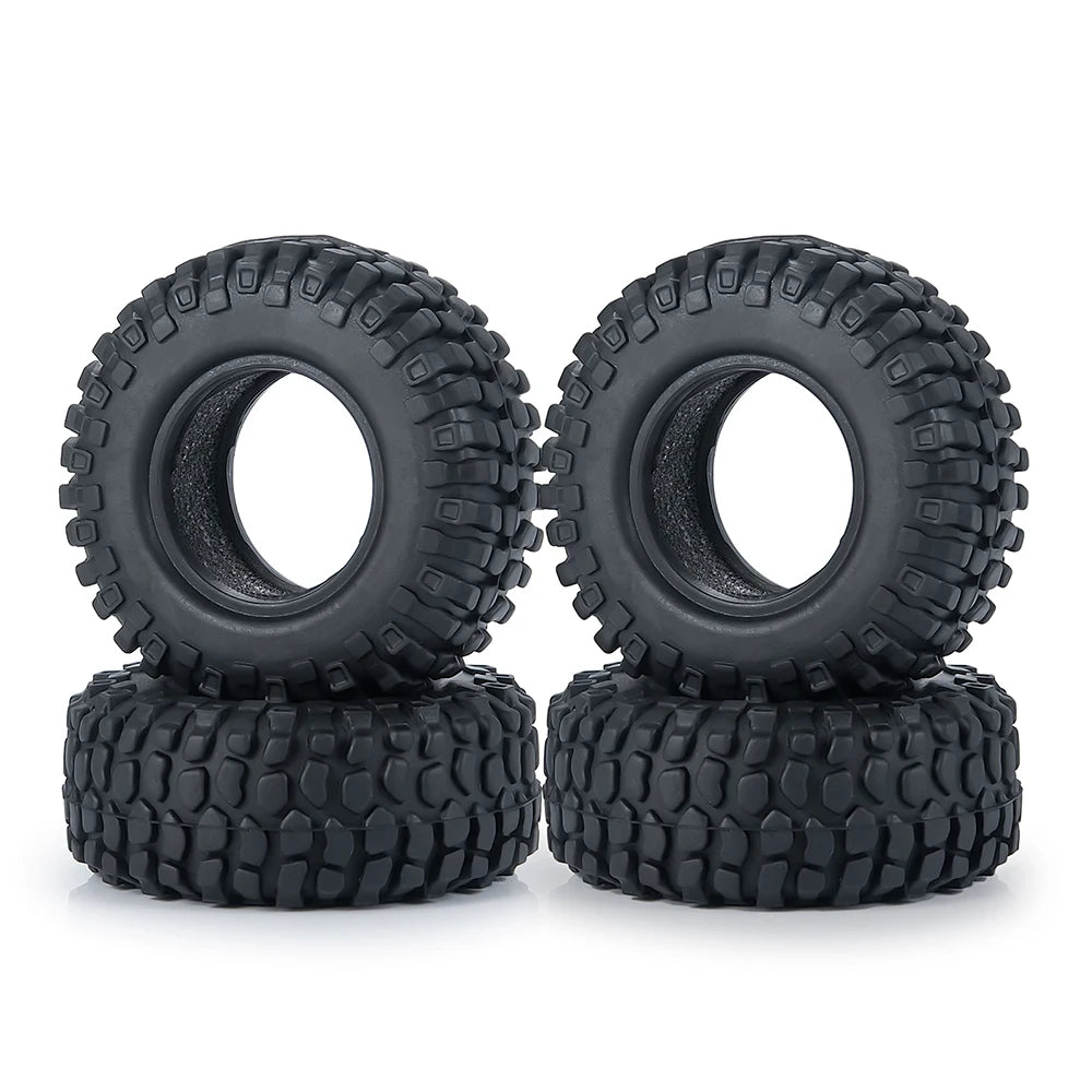 A set of black rubber mud terrain tires stacked on a white background.