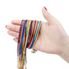 A hand holds a bundle of colorful leather cords and threads for an adjustable necklace.