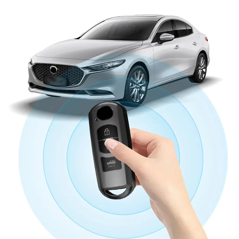 A hand holds a black TPU car key cover, demonstrating its proximity sensor function near a Mazda vehicle.
