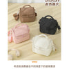 A display of various insulated lunch bags in brown, black, and pink colors.