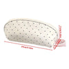 A cream-colored shell-shaped pencil case with polka dots and multi-compartment storage.