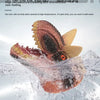 A realistic dinosaur hand puppet toy is being washed with water and soap bubbles.
