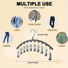 A black stainless steel multi-use hanger with ten clips used to organize various types of pants and clothing in a closet.