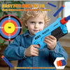 A young boy is holding a blue foam dart blaster toy aimed at a target, demonstrating its use.