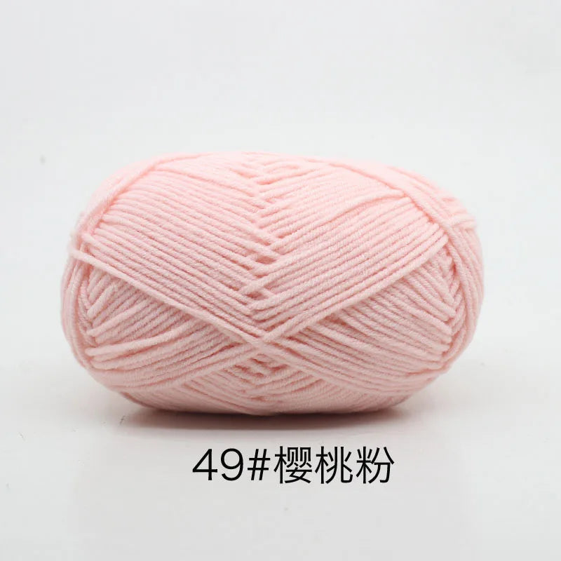 A ball of soft pink 4-ply milk cotton yarn for knitting and crochet.
