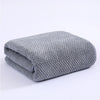 A folded gray knitted bath towel with a textured pattern.