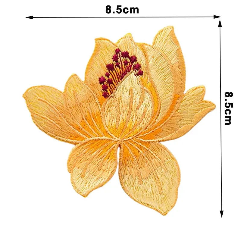 Yellow embroidered iron-on patch of a flower resembling a rose with reddish center details.