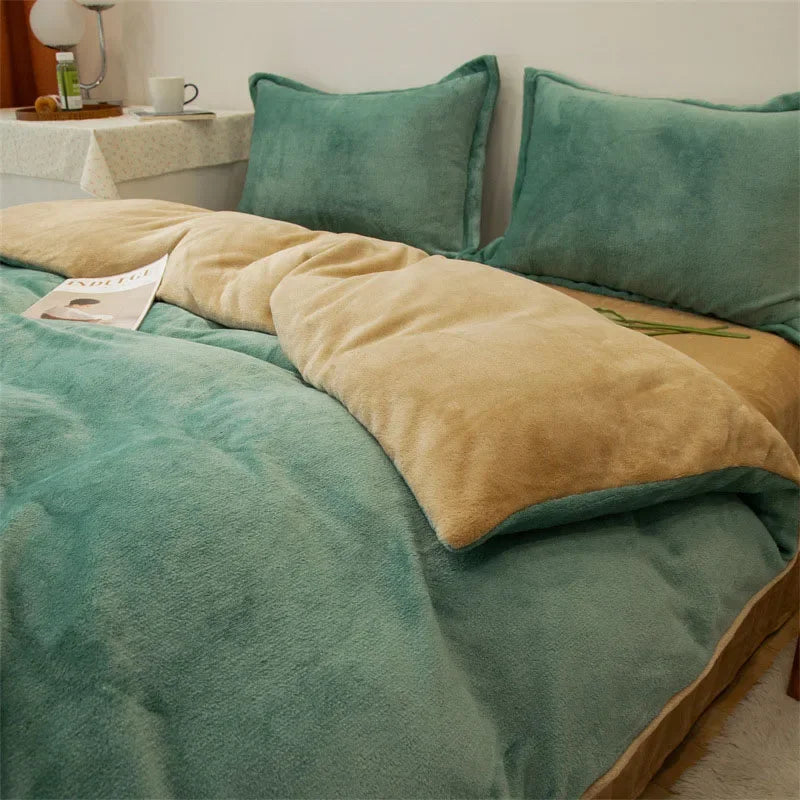 A teal flannel duvet cover with a tan throw and matching pillows on a bed.
