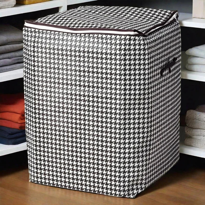 A large checkered fabric storage bag with handles is placed on a shelf among folded textiles.