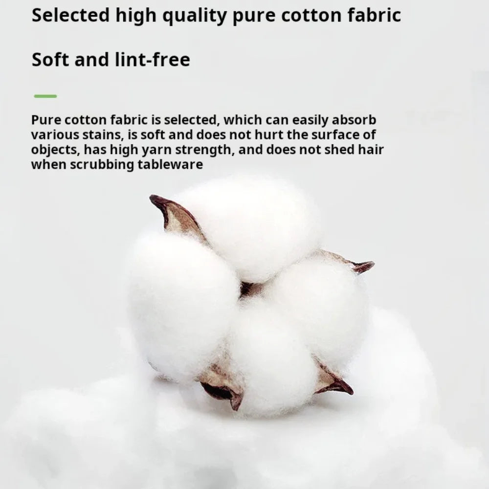 A close-up of four fluffy white cotton towels resting on a light surface.