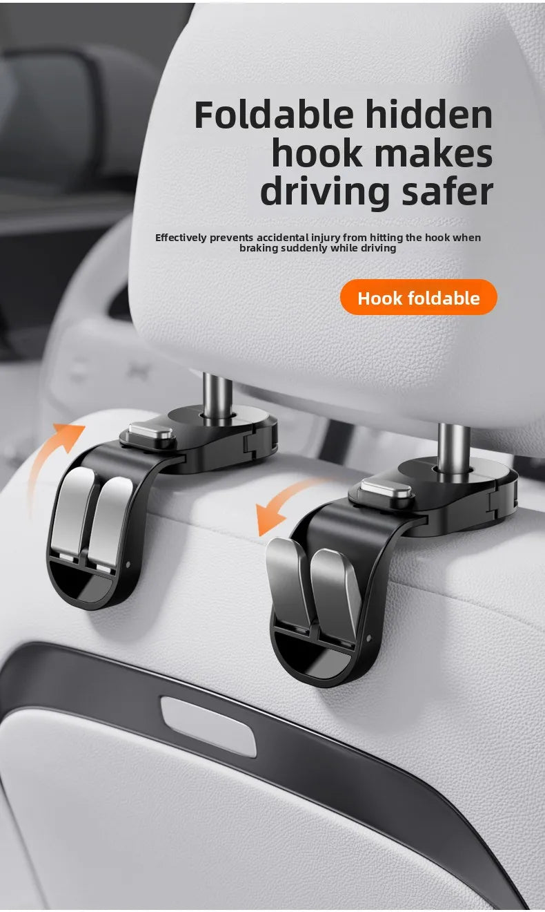 A close-up of a foldable hidden hook mechanism attached to a car seat headrest.