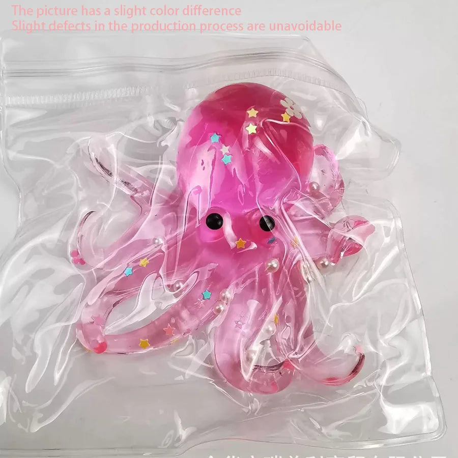 A pink squishy toy shaped like an octopus with glitter accents is sealed in a clear plastic bag.