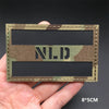 A rectangular tactical patch featuring a camouflage pattern with the letters N.L.D. displayed in white text.