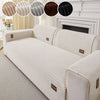A beige ribbed sofa cushion cover displayed with color options and a white fireplace mantel in a bright room.