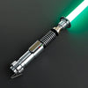 A metallic lightsaber hilt with a glowing green blade is shown against a dark background.