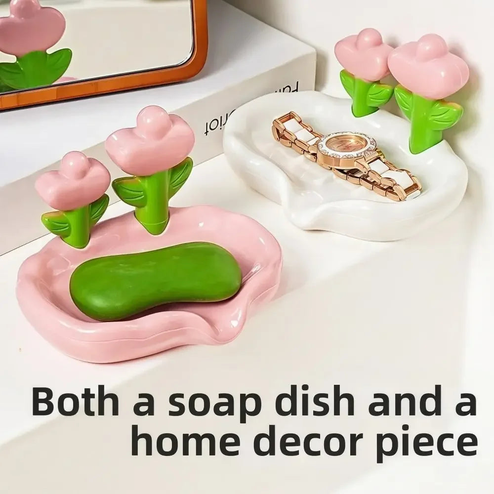 A set of pink and green ceramic soap dishes and a gold-colored home decor piece.