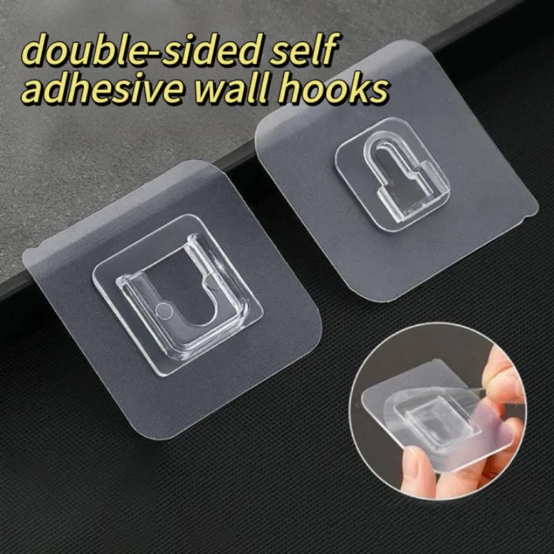 Two clear double-sided adhesive wall hooks are shown, with a close-up of one being held by a hand.
