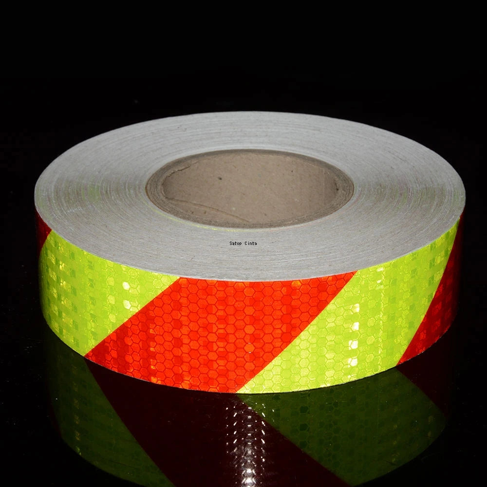 Roll of high-visibility reflective tape featuring a honeycomb pattern in yellow and orange colors.