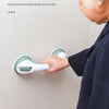 An elderly person is using a white suction cup safety grab bar attached to a wall, demonstrating multiple layers of protectio