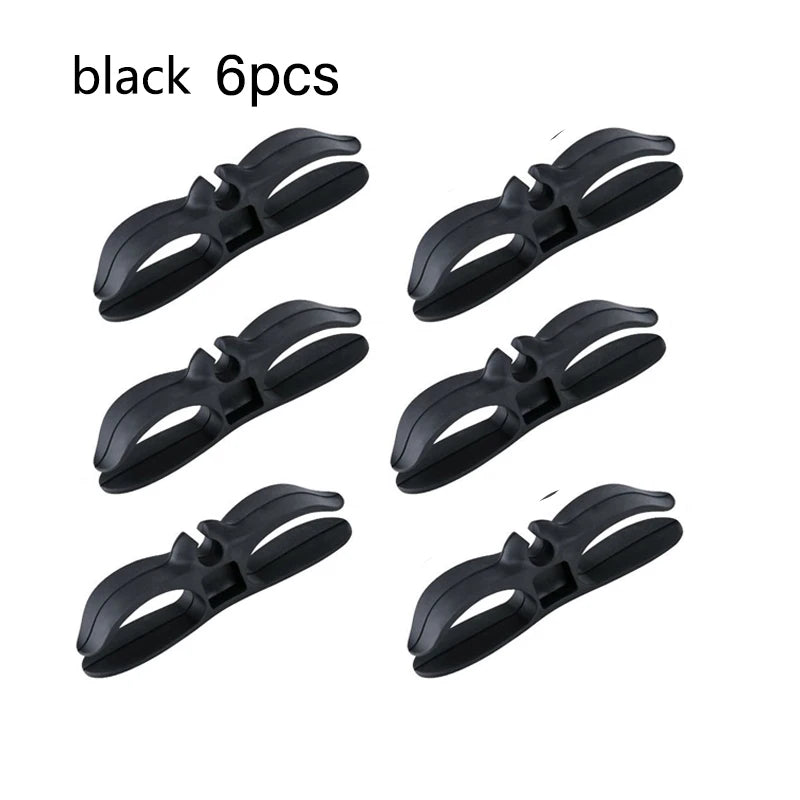 Six black cord organizers or wire winders for tidy cable management.