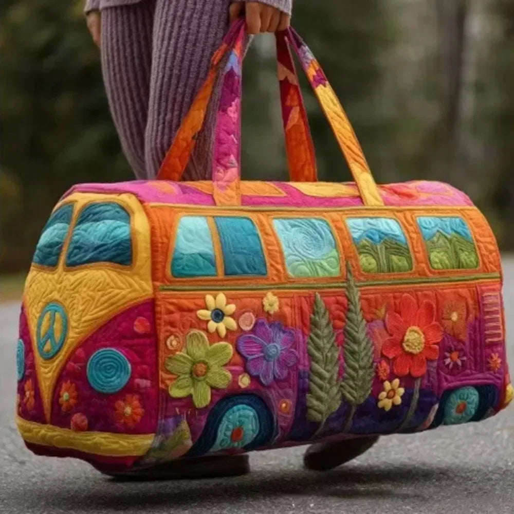 A vibrant orange and purple quilted travel duffle bag with green accents is being carried by a person outdoors.
