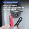 A hand holds a red door lock shock-absorbing rubber ring and a black door lock ring against a gray door surface.
