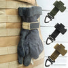 A pair of dark gray nylon gloves with adjustable clips are shown hanging on a beige woven strap.