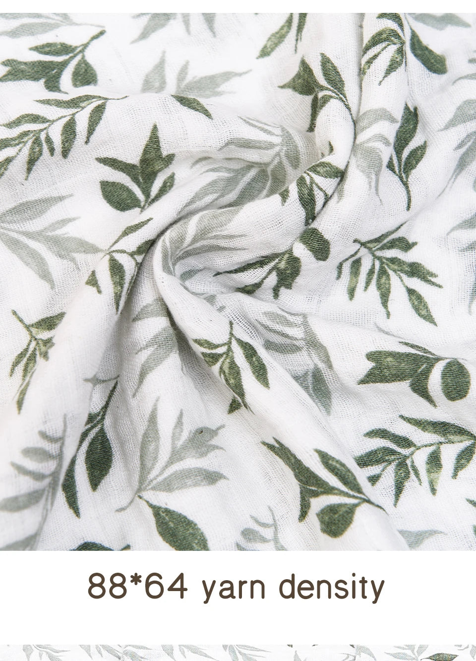 Close-up of white muslin fabric with green leaf print showing yarn density.