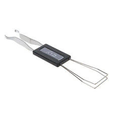 A silver anti-static keycap puller tool with a black handle and metal wires for removing mechanical keyboard keycaps.