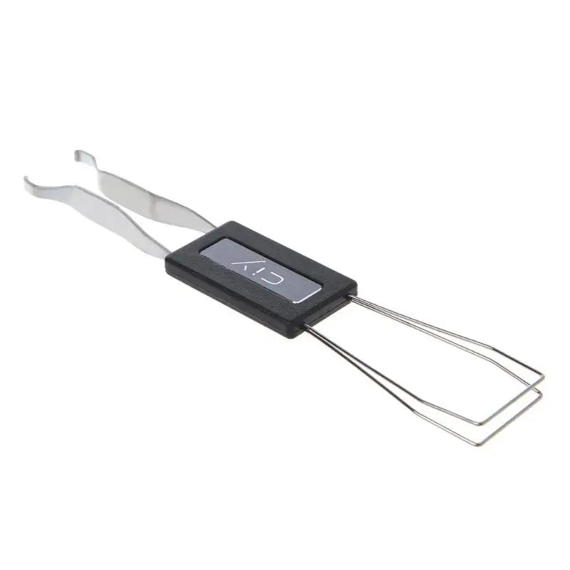 A silver anti-static keycap puller tool with a black handle and metal wires for removing mechanical keyboard keycaps.
