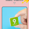 A hand is holding a green wooden block with the number 9 on it, demonstrating a Montessori counting toy.