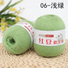 A ball of light green yarn labeled 06-Silk, ready for knitting or crochet.