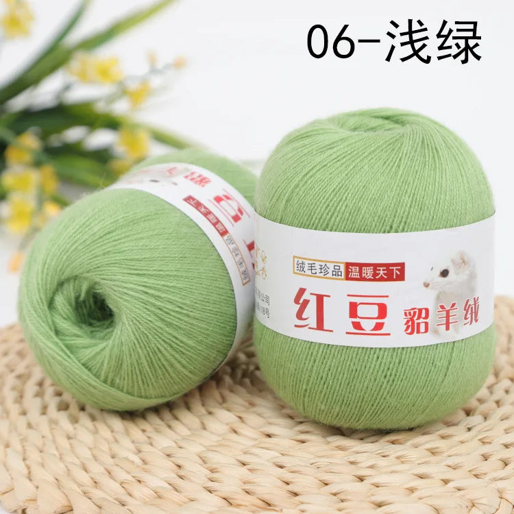 A ball of light green yarn labeled 06-Silk, ready for knitting or crochet.