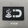Black embroidered patch featuring a white stylized flame and a capital D letter on a gray background.