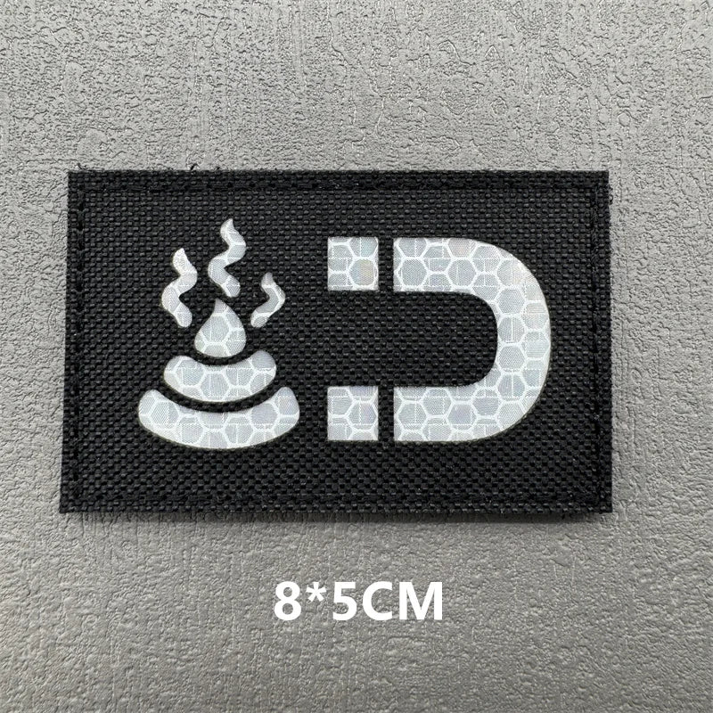 Black embroidered patch featuring a white stylized flame and a capital D letter on a gray background.